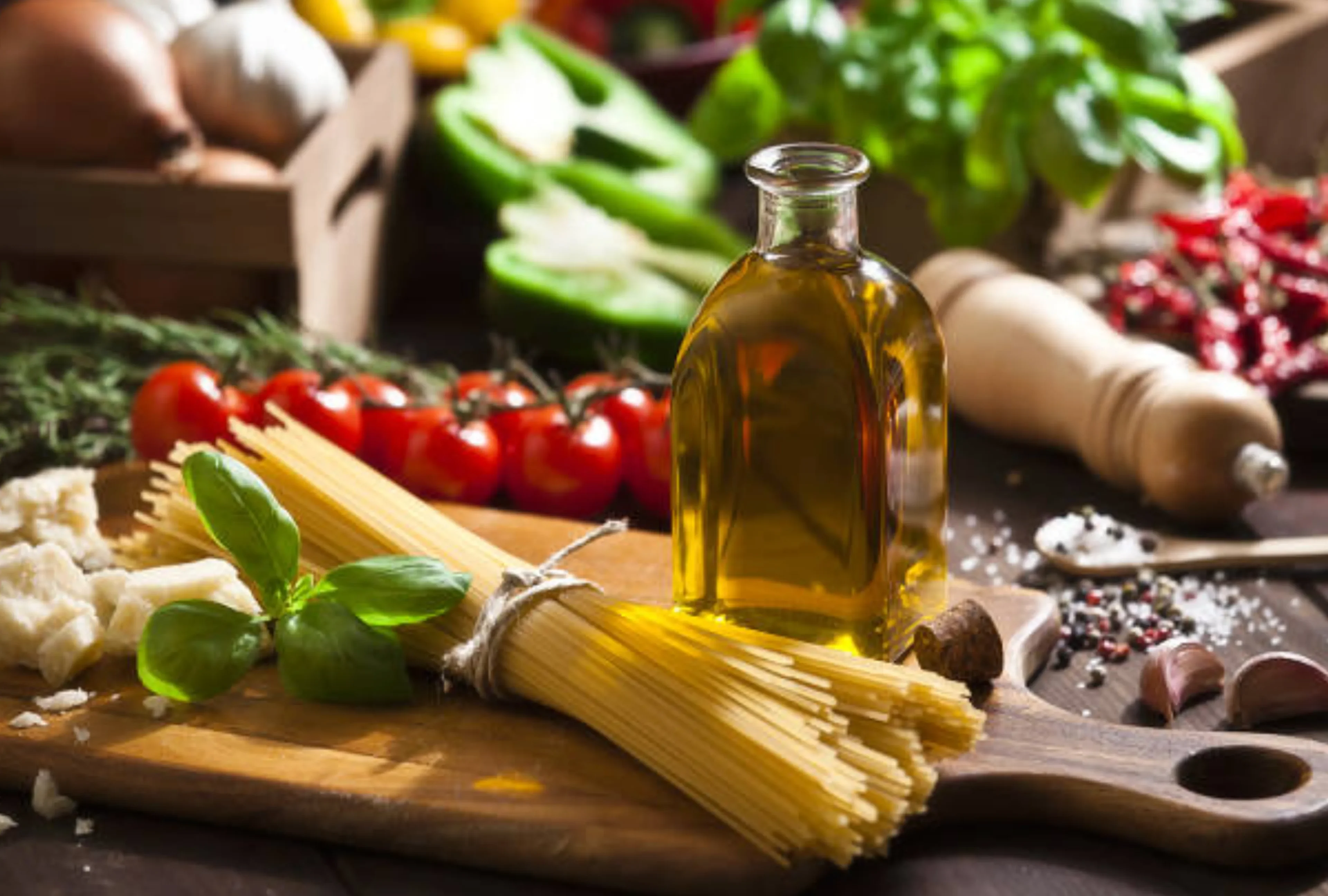 82e73003-2386-4aa8-975b-2d83aed2752d 1 (1) A wooden cutting board topped with pasta next to tomatoes.