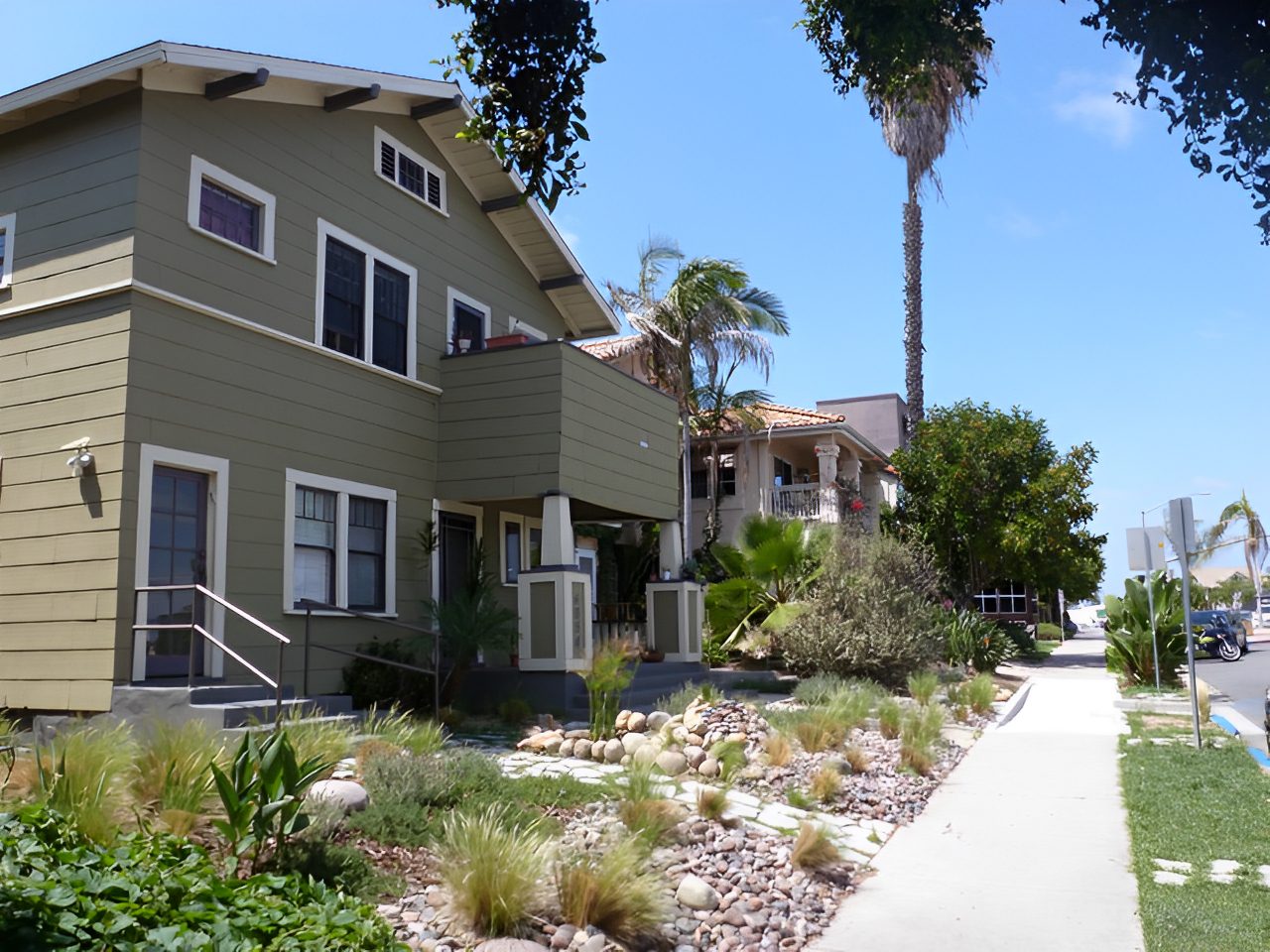 A street with plants and bushes in the front of it.