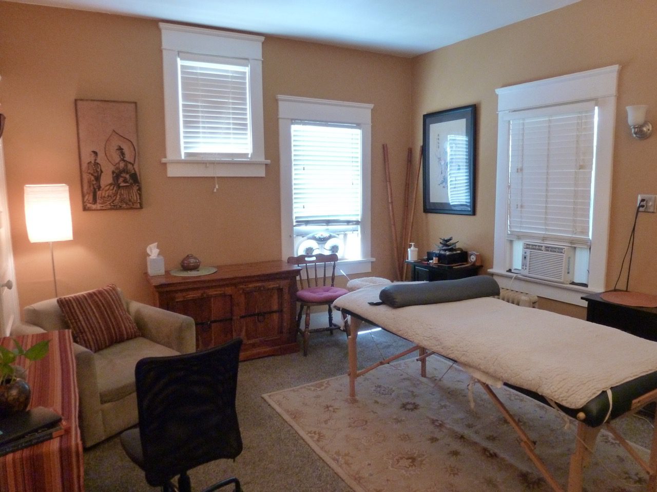 A room with a couch, chair and table in it.